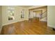 Bright living room with hardwood floors, large windows and hallway leading to the stairs at 6195 Mountainwell Dr, Roswell, GA 30075