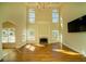 Bright living room with fireplace, chandelier and floor to ceiling windows at 6195 Mountainwell Dr, Roswell, GA 30075