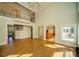 Bright living room with fireplace, chandelier, floor to ceiling windows and access to the kitchen at 6195 Mountainwell Dr, Roswell, GA 30075
