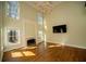 Bright living room with fireplace, chandelier and floor to ceiling windows at 6195 Mountainwell Dr, Roswell, GA 30075