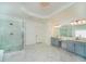 Bright and airy main bathroom with double vanity, tiled floors, a stand alone tub and glass shower at 6195 Mountainwell Dr, Roswell, GA 30075