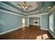 Bright main bedroom with wood floors, decorative ceiling, and a fireplace in the connected sitting room at 6195 Mountainwell Dr, Roswell, GA 30075