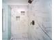 Close up of the tile shower featuring a glass enclosure and built in shelves at 6195 Mountainwell Dr, Roswell, GA 30075