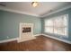 Bedroom sitting room with a fireplace, wood floors, and natural light at 6195 Mountainwell Dr, Roswell, GA 30075