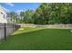 A spacious backyard featuring an enclosed, well-maintained lawn surrounded by a wooden fence at 671 Stickley Oak Way, Woodstock, GA 30189