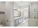 Modern bathroom featuring double sinks, a vanity with gray cabinets, and a walk-in shower at 671 Stickley Oak Way, Woodstock, GA 30189
