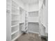 Bright walk-in closet features custom shelving, ample storage, and stylish design for efficient organization at 671 Stickley Oak Way, Woodstock, GA 30189