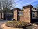 Stone entrance to community features flower bed and stone walls at 671 Stickley Oak Way, Woodstock, GA 30189
