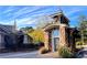Stone community entrance with a small guardhouse, landscaping, and architecture at 671 Stickley Oak Way, Woodstock, GA 30189