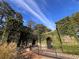 Gated entrance featuring brick walls covered in ivy and lush greenery at 671 Stickley Oak Way, Woodstock, GA 30189