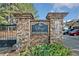 Stone entrance sign for The Village at Towne Lake David Pearson Communities with flowerbed at 671 Stickley Oak Way, Woodstock, GA 30189