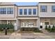 Charming townhome exterior featuring gray siding, well-maintained landscaping, and a covered front porch at 671 Stickley Oak Way, Woodstock, GA 30189