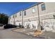 Townhome exterior featuring individual garages, neutral siding, and well-lit entrances at 671 Stickley Oak Way, Woodstock, GA 30189