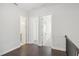 Bright hallway with three doors and hardwood floors at 671 Stickley Oak Way, Woodstock, GA 30189