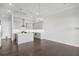 Bright open-concept kitchen with gray cabinets, stainless appliances, and dark wood flooring at 671 Stickley Oak Way, Woodstock, GA 30189
