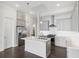 Bright kitchen features gray cabinets, stainless steel appliances and a large island with a sink at 671 Stickley Oak Way, Woodstock, GA 30189