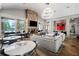 The living room showcases a stone fireplace, large windows, and modern lighting fixtures at 671 Stickley Oak Way, Woodstock, GA 30189
