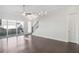Open living room with wood floors, ceiling fan, slider doors to patio, and staircase at 671 Stickley Oak Way, Woodstock, GA 30189