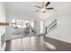 Bright living room with ceiling fan, fireplace, staircase and glass doors to the backyard at 671 Stickley Oak Way, Woodstock, GA 30189