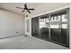 Covered patio with a ceiling fan, sliding glass doors, and view of the neighborhood at 671 Stickley Oak Way, Woodstock, GA 30189