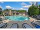 An outdoor swimming pool area, surrounded by chairs, umbrellas and an outdoor grilling area at 671 Stickley Oak Way, Woodstock, GA 30189