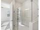 Modern walk-in shower with white marble tile and glass door at 671 Stickley Oak Way, Woodstock, GA 30189