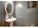 Stylish half bath featuring a pedestal sink, oval mirror, and tasteful decor at 1769 Old Dogwood, Jonesboro, GA 30238