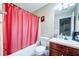 Bathroom featuring a tub, shower with a red curtain, toilet, and vanity with sink at 1769 Old Dogwood, Jonesboro, GA 30238