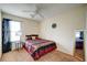 Comfortable bedroom with striped bedspread, ceiling fan, and window with natural light at 1769 Old Dogwood, Jonesboro, GA 30238