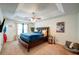 Spacious bedroom featuring a tray ceiling, ceiling fan, and ample natural light at 1769 Old Dogwood, Jonesboro, GA 30238