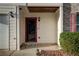Charming townhouse entrance with red door, address, and manicured landscaping at 1769 Old Dogwood, Jonesboro, GA 30238