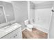 Clean bathroom with a white vanity, toilet, and shower-tub combo at 2473 Chauncey Sw Ln, Marietta, GA 30064