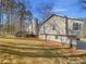 Exterior view of the home with a deck, chimney and mature trees in the landscaped yard at 2473 Chauncey Sw Ln, Marietta, GA 30064