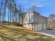 Exterior view of the home showcasing the garage, chimney, siding and landscaped yard at 2473 Chauncey Sw Ln, Marietta, GA 30064