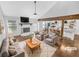 Bright, staged living room with a stone fireplace and open access to the modern kitchen at 2473 Chauncey Sw Ln, Marietta, GA 30064