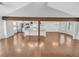 Open-concept living room featuring hardwood floors, exposed beams, and bright kitchen with stainless steel appliances at 2473 Chauncey Sw Ln, Marietta, GA 30064