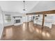 A well-lit living room with hardwood floors, a fireplace and open view to the modern kitchen at 2473 Chauncey Sw Ln, Marietta, GA 30064