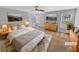 Staged main bedroom with neutral walls and carpet, complemented by natural light from the windows at 2473 Chauncey Sw Ln, Marietta, GA 30064