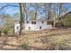 Back exterior of home with white painted brick, surrounded by a wooded lot with mature trees at 2695 Terratim Ln, Decatur, GA 30034