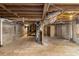 Unfinished basement area featuring concrete floor, exposed beams, and utilities at 2695 Terratim Ln, Decatur, GA 30034