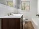Bathroom featuring white subway tile, updated vanity, wood look tile floors, and natural light at 2695 Terratim Ln, Decatur, GA 30034