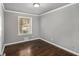 Cozy bedroom with hardwood floors and a window letting in natural light at 2695 Terratim Ln, Decatur, GA 30034