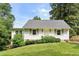 Charming home featuring a well-manicured lawn, blooming bushes, and a classic painted brick exterior at 2923 Ridgemore Nw Rd, Atlanta, GA 30318