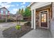 Inviting front porch with stone accents and a well-manicured garden bed at 2797 Middlecreek Way, Cumming, GA 30041