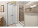 Tiled walk-in shower features glass doors and brushed nickel shower head at 2797 Middlecreek Way, Cumming, GA 30041