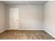 Bright bedroom with neutral walls, a standard door, and plush brown carpet flooring at 3062 Hawthorn Farm Blvd, Loganville, GA 30052
