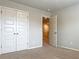 Bedroom with double closets and view into the hallway at 3062 Hawthorn Farm Blvd, Loganville, GA 30052