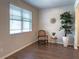 Cozy living room with a large window, a comfortable chair, and a decorative tree at 3062 Hawthorn Farm Blvd, Loganville, GA 30052