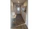 Bright hallway with wood floors, decorative wall art, and a view to the white door and sunlit exterior at 736 Great Oak Pl, Villa Rica, GA 30180