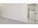 Bright bedroom featuring plush gray carpeting and an adjacent bathroom with a marble-tiled shower at 1096 Glen Opal Dr, Decatur, GA 30032
